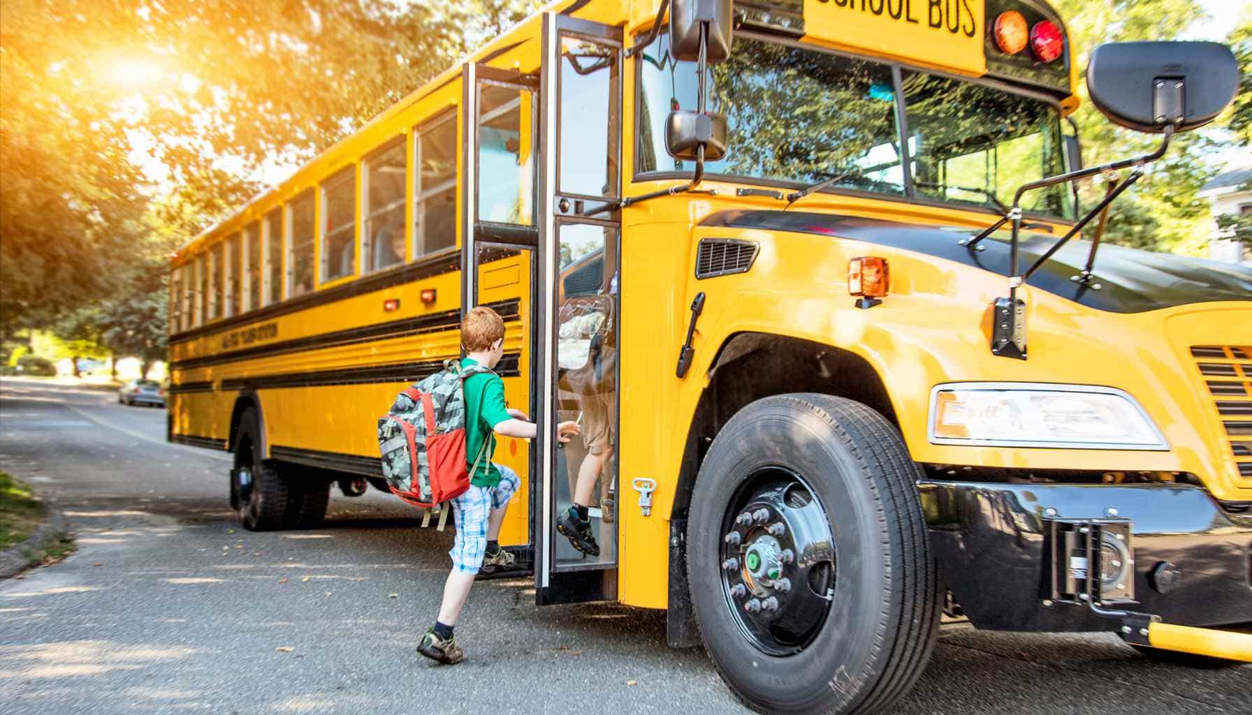 boy getting onto school bus