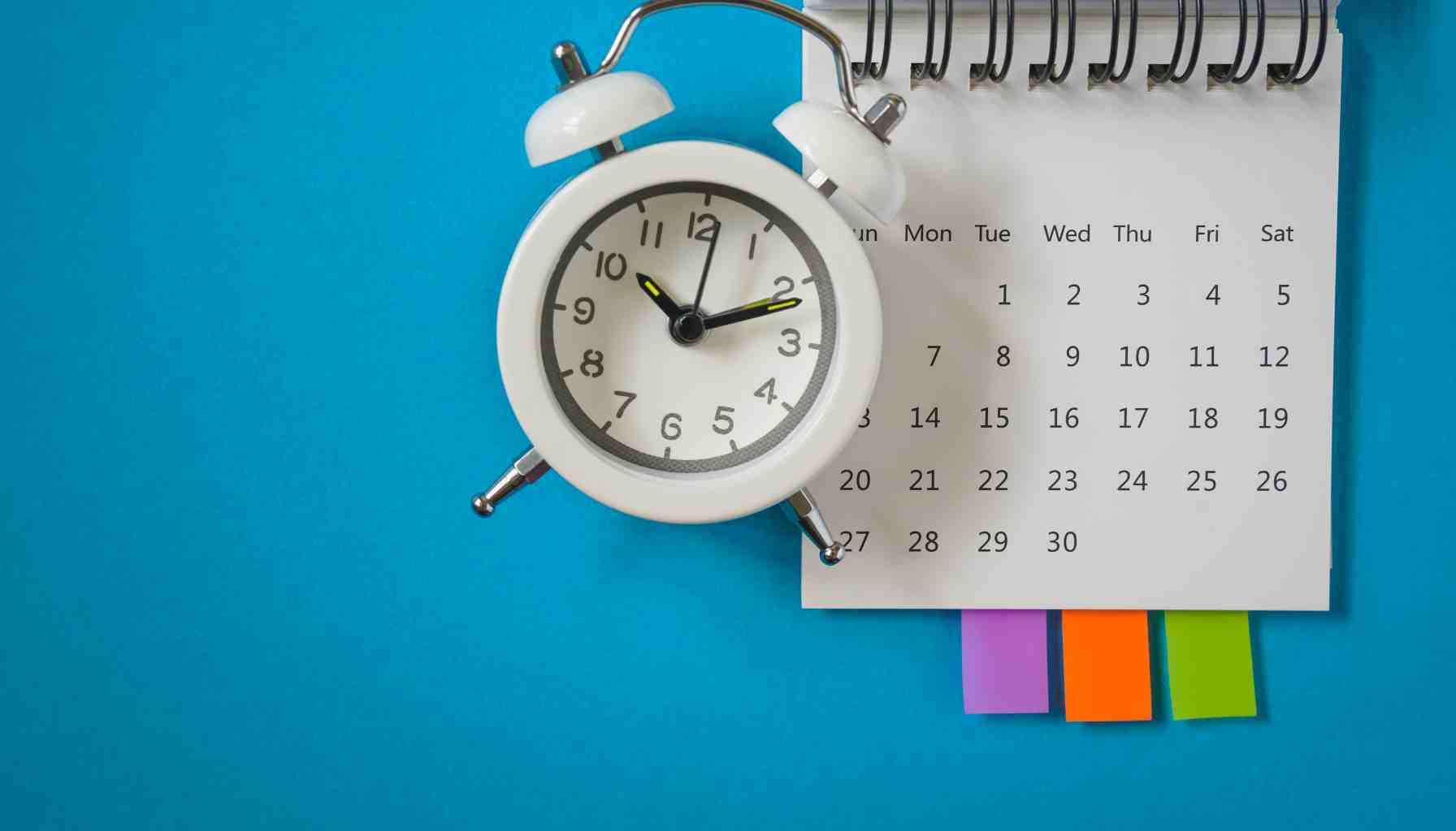 calendar with a clock ticking and sticky notes